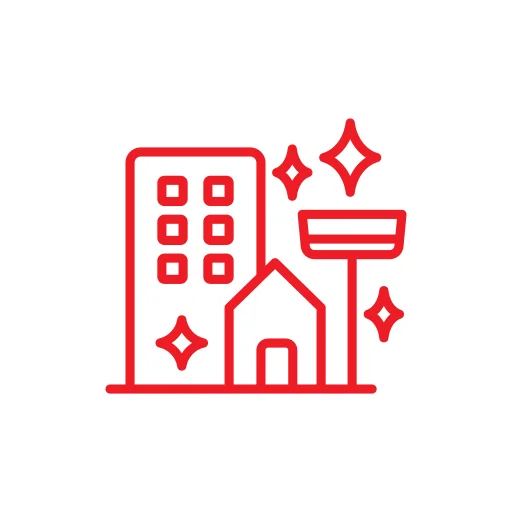 A red outlined icon depicting a tall building, a house, a streetlamp, and several sparkles, representing cleanliness or maintenance, set against a white circular background.